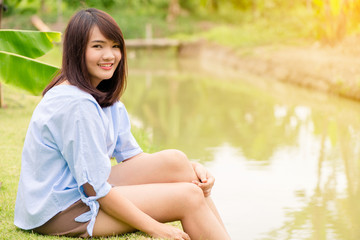 Woman smiling with perfect smile and white teeth in a park and looking at camera