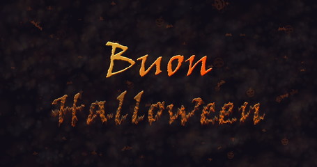 Buon Halloween text in Italian dissolving into dust to bottom.