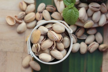 Pistachio nuts is tasty on wood background.