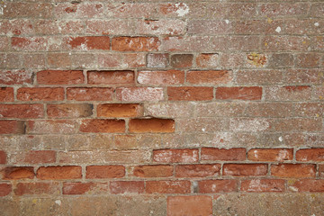 A full page of decaying red brick wall background texture