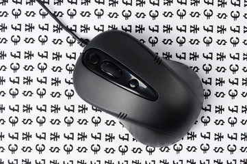 computer mouse on a background of signs of money