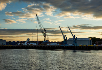 Fototapeta na wymiar Blyth Harbour, Northumberland, England, UK. At sunset. View looking towards dock and cranes.