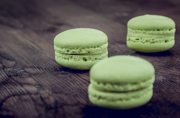 green cake macaron on wood background, maccarone sweet dessert