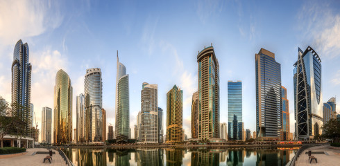 Panoramic view of Business bay and Lake Tower, reflection in a river, UAE