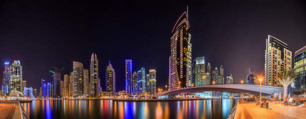 Panoramic view of Dubai Marina bay with yacht and cloudy sky, Dubai, UAE