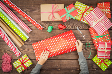Female hands wrapping christmas presents
