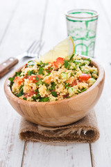 Tabbouleh salad with couscous on a white table

