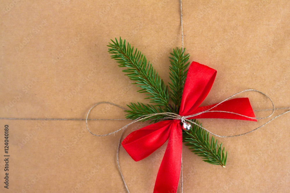 Poster holiday gift wrapping with a red bow and rope