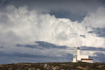 Fototapeta na wymiar Fair Isle lighthouse with dramatic sky