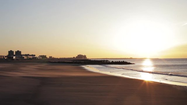 Sunrise seascape and sand drifts, Rockaway Beach, New York.
