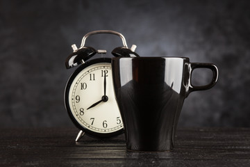 Alarm clock and a cup of coffee