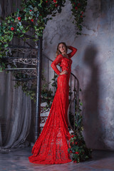 Fototapeta na wymiar Girl in red dress enthralling