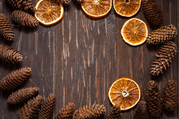 dark wood background with cones and dry orange  with copy space