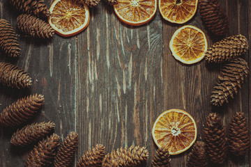 dark wood background with cones and dry orange  with copy space