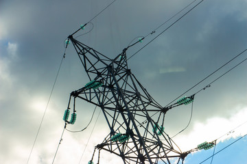 A high voltage power pylons against sky. The photo shows a sky with cloud