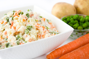 Russian salad and ingredients isolated on white background

