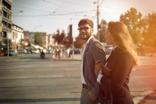 Happy business couple in street