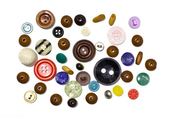 Multi-colored buttons and beads on white background.