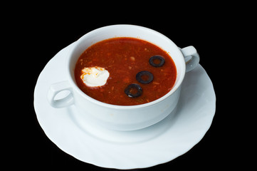 Soup with different types of meat. Soup with tomatoes and olives.
