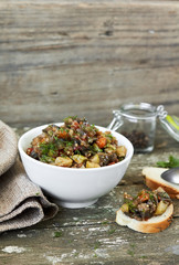 Vegetable caviar with baguette on wooden surface. vertical