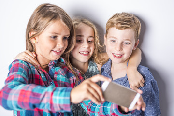 Group of happy children in studio gray background
