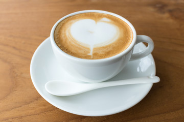 Top view coffee cup latte art on wood table.
