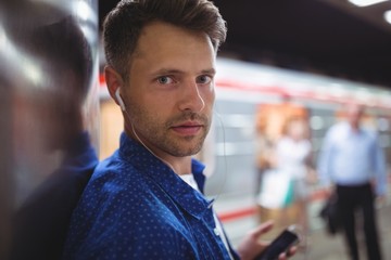 Portrait of handsome man listening song on mobile phone