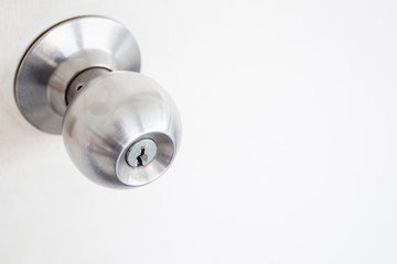 Doorknob in wooden door close up.