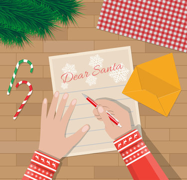 Child Hand with pen Writing letter to santa claus
