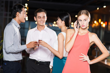 Woman Calling on Phone and Friends Toasting