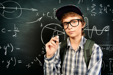 standing by a blackboard