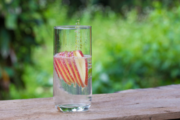Detox water with apples on table
