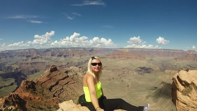 Woman with selfie-stick at Grand Canyon.