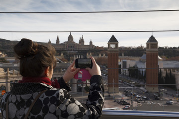 Woman taking a photo with a mobile in Barcelona