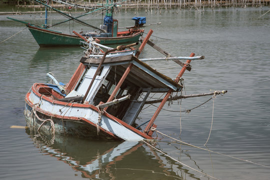 traditional fishing boat capsize into the sea .filtered image.selective focus