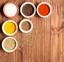 Spices on brown rustic wooden background, soft focus, square
