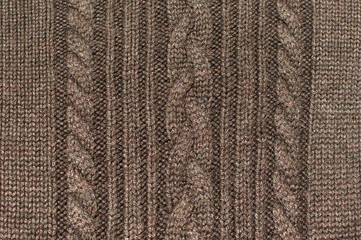 Texture of brown knitted wool sweater with ornament
