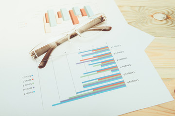 business concept : graph with glasses on stock market report as