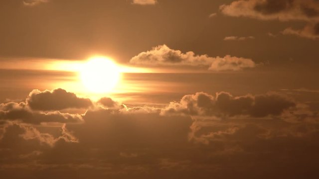 Sun drops behind beautiful cloudscape, time lapse day to night. Reverse for sunrise effect.