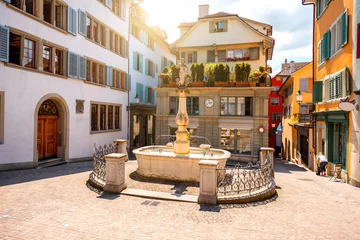 Poster Im Rahmen Beautiful small square with fountain in the old town of Zurich city in Switzerland © rh2010
