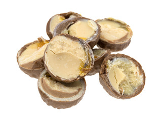 Cut chocolate hazelnut cream truffles on a white background.