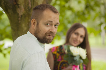 Fototapeta premium portrait of a man and woman with flowers in nature