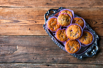 Tasty homemade muffins on silver tray. Top view. Copyspace