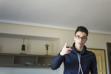 boy with glasses pointing