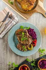 Grilled pork chops with herbs and garlic, potato pancakes
