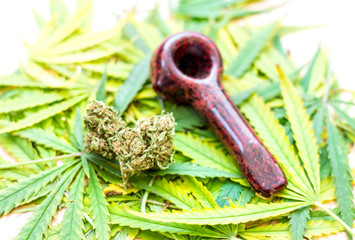 Glass pipe, marijuana leaves (cannabis), hemp for illegal smoking