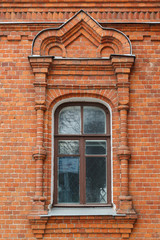 Carved window of old brick house