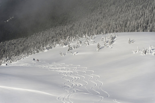 Skiers At The Base Of A Mountain; Whistler, British Columbia, Canada