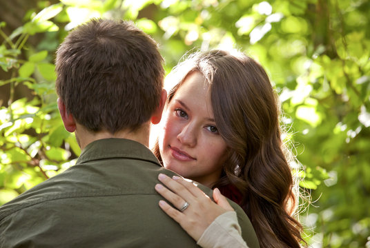 Newlywed Couple Embracing In A Park; Edmonton, Alberta, Canada