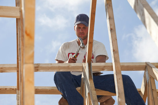 Tradesman Working On Framing For New Home Construction; St. Albert, Alberta, Canada